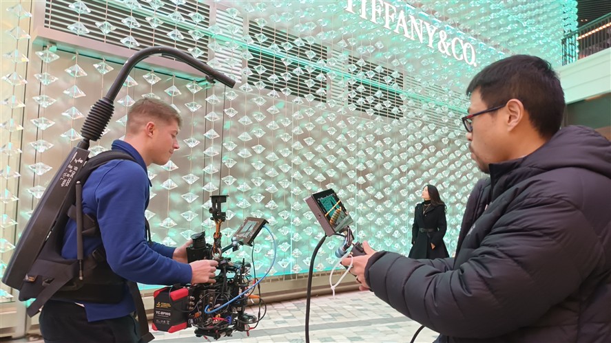 Shenzhen production crew preparing camera and lighting gear inside a stylized interior location