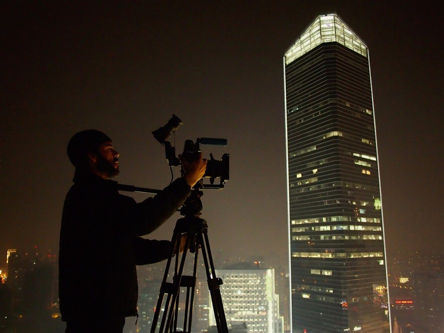 Shenzhen filming crew at night with city lights in the background