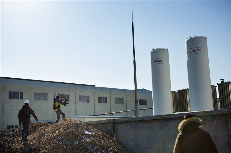 Shenzhen production crew coordinating a shoot in an industrial location